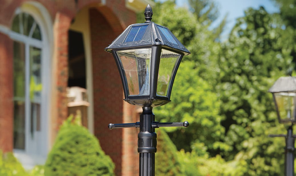 black Bay Town II Outdoor Solar Lamp with Post in front yard of home