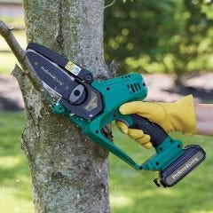 pruner saw cutting tree limbs 