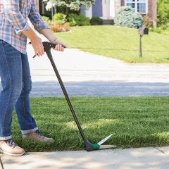 model using grass shears outside 