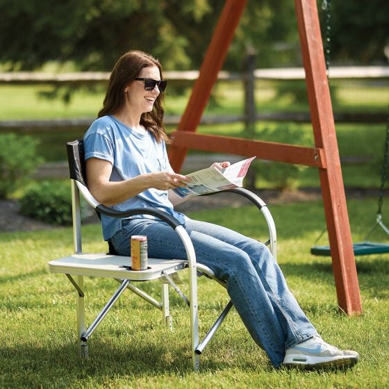 model sitting in lawn chair outside model sitting in lawn chair outside