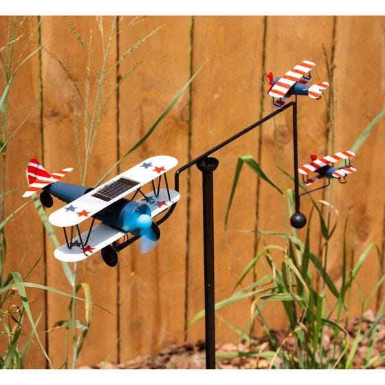 biplane balancer in front of fence 