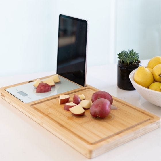 cutting board on table with potatoes cutting board on table with potatoes