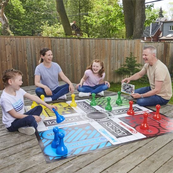 family playing the Giant Sorry game outside family playing the Giant Sorry game outside