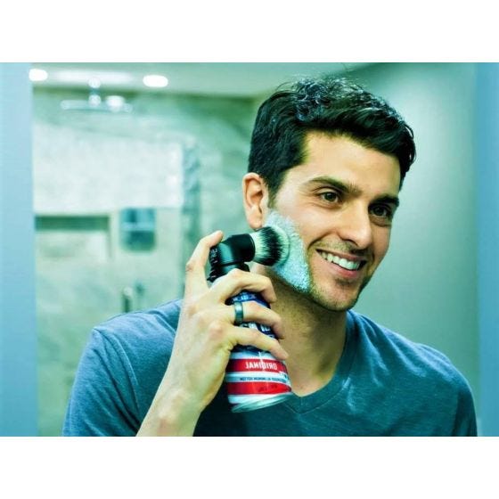 Legacy Shave Brush on shaving can being used by model Legacy Shave Brush on shaving can being used by model
