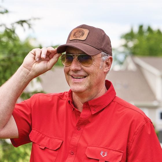 model wearing brown ball cap