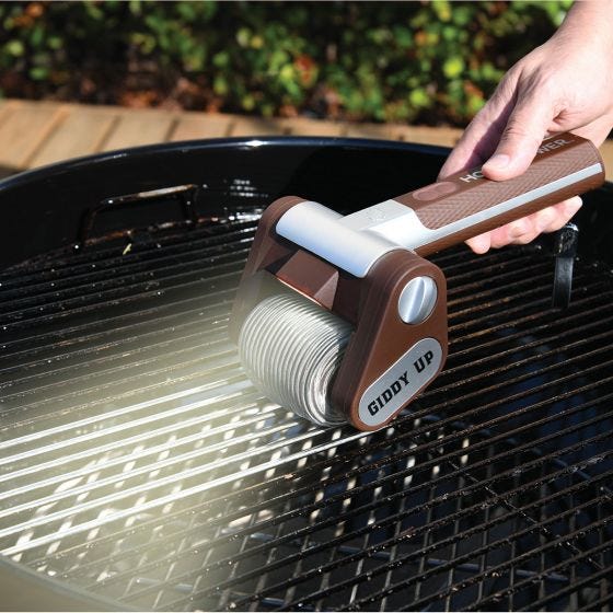 model using grill brush to clean grill 