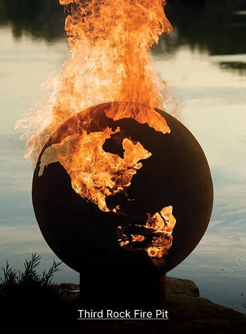 third rock fire pit globe shaped to represent earth in front of lake with fire roaring